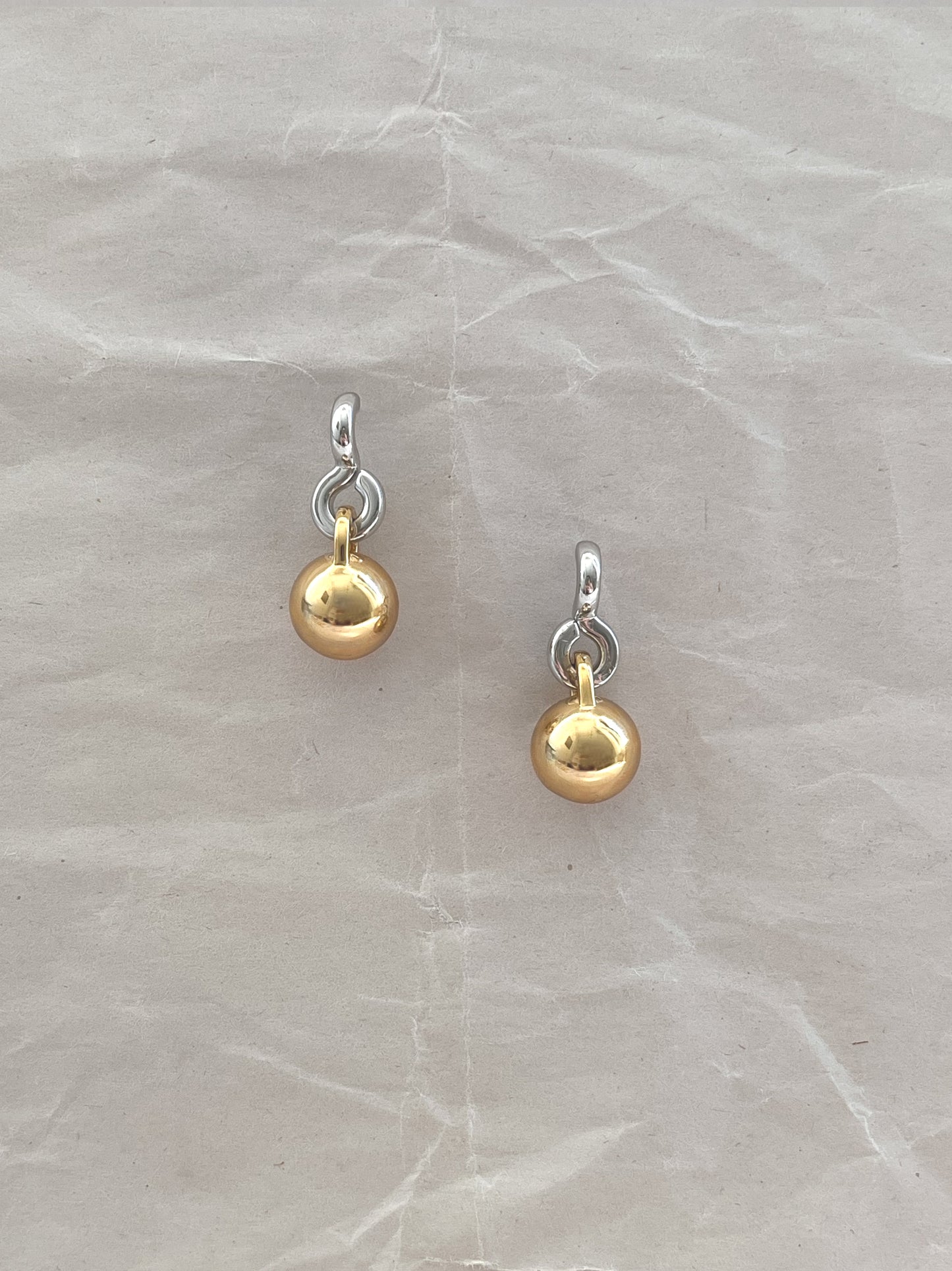 Laura Lombardi Two Tone Gioca drop earrings on a white paper background.