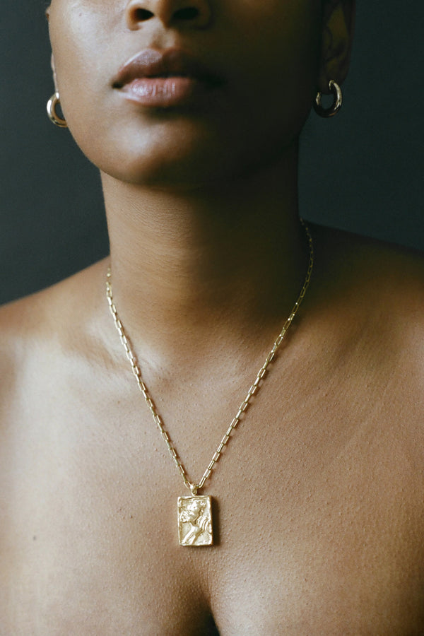 Model wearing AMS x LL gold Leonne Pendant