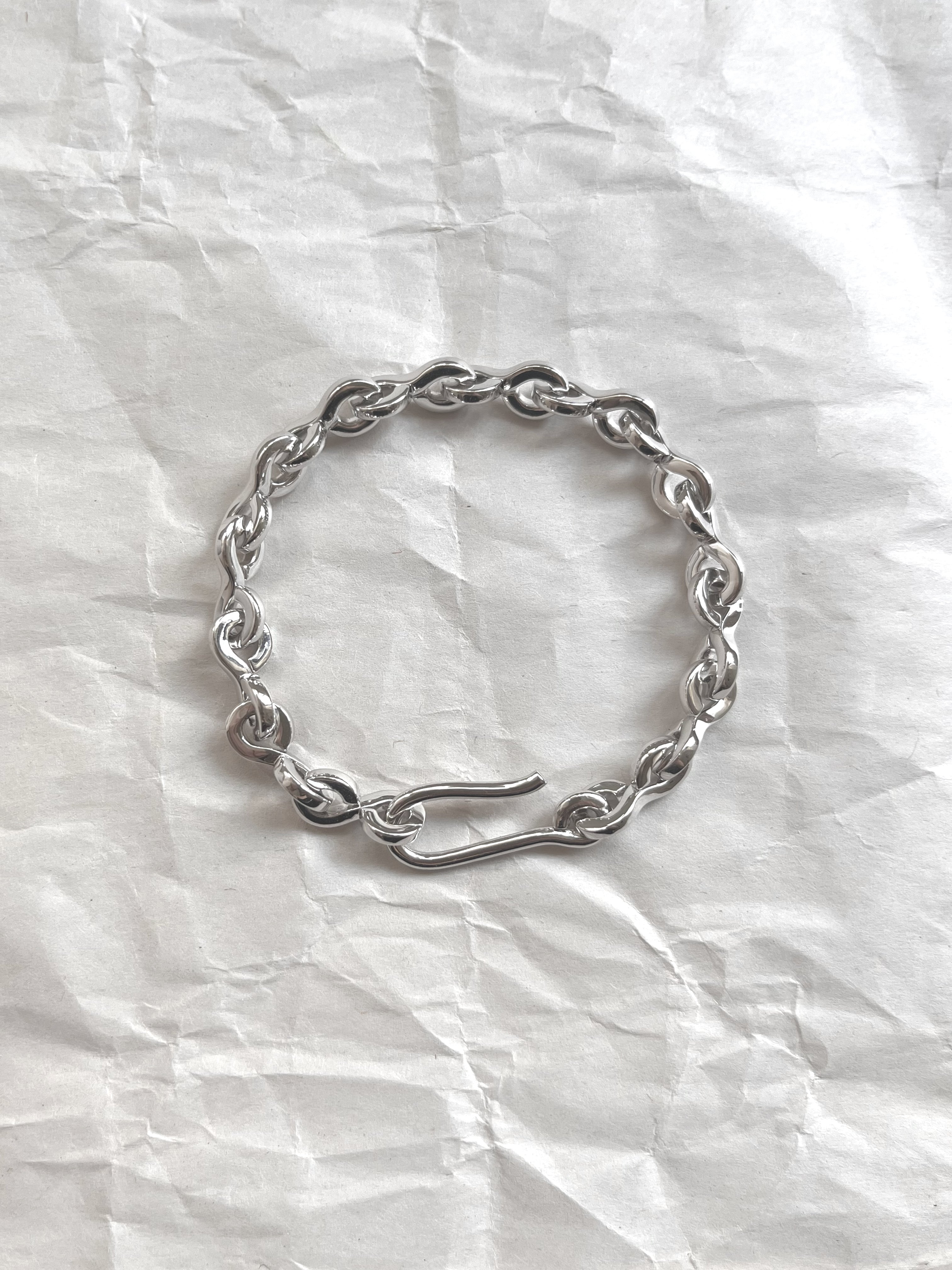 Laura Lombardi Silver Nuova chain bracelet on a white paper background.