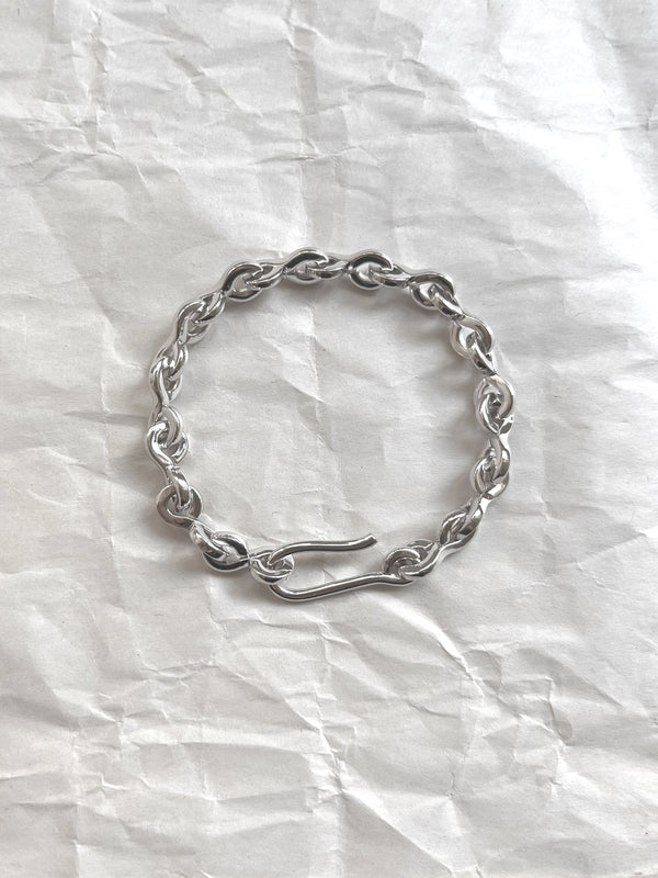 Laura Lombardi Silver Nuova chain bracelet on a white paper background.