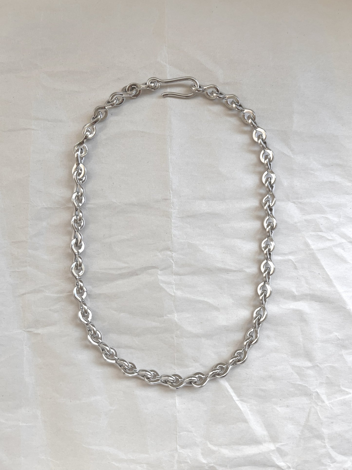 Laura Lombardi Silver Nuova chain necklace on a white paper background.