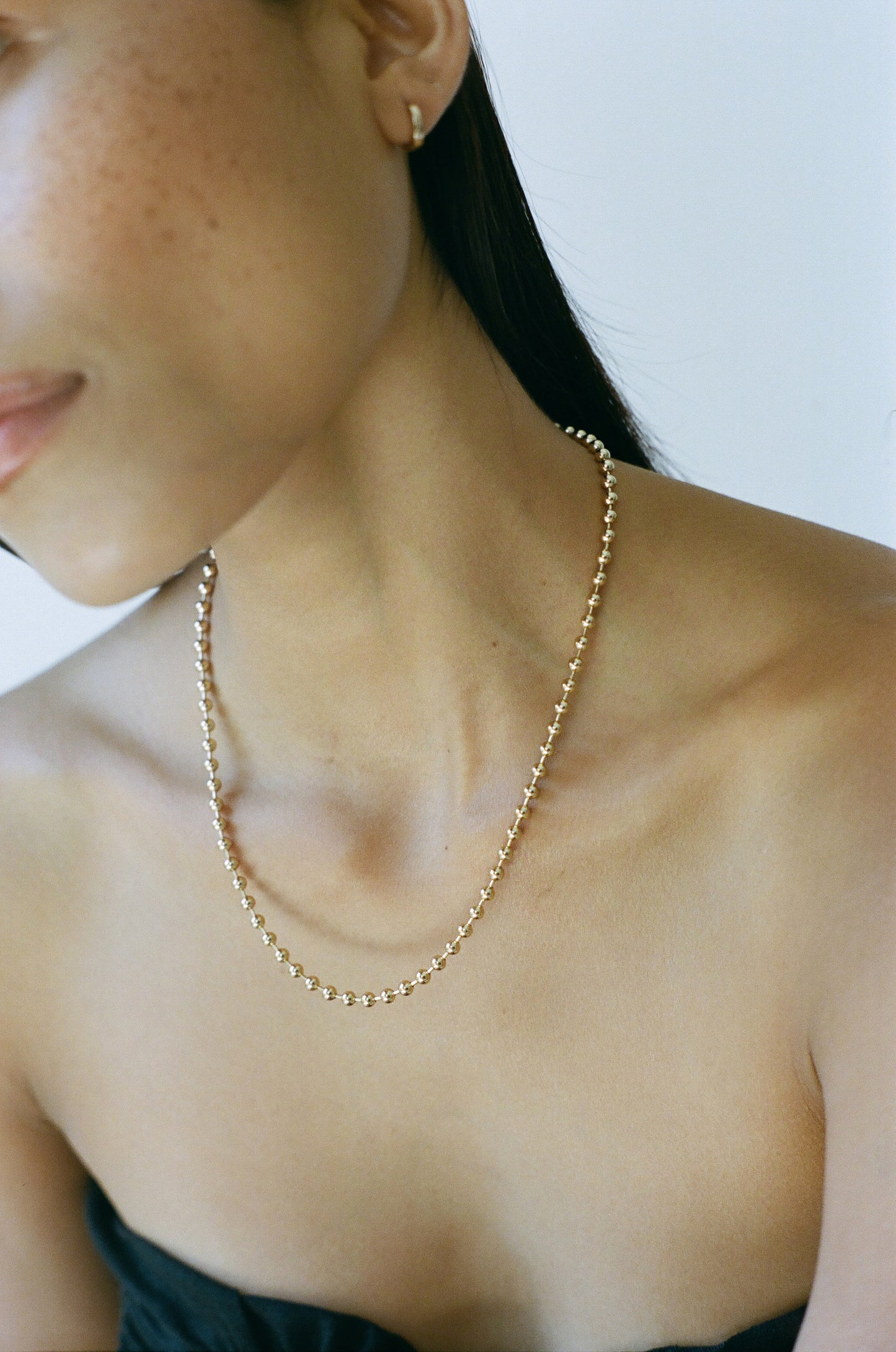 Model wearing Laura Lombardi gold Ball Chain Necklace
