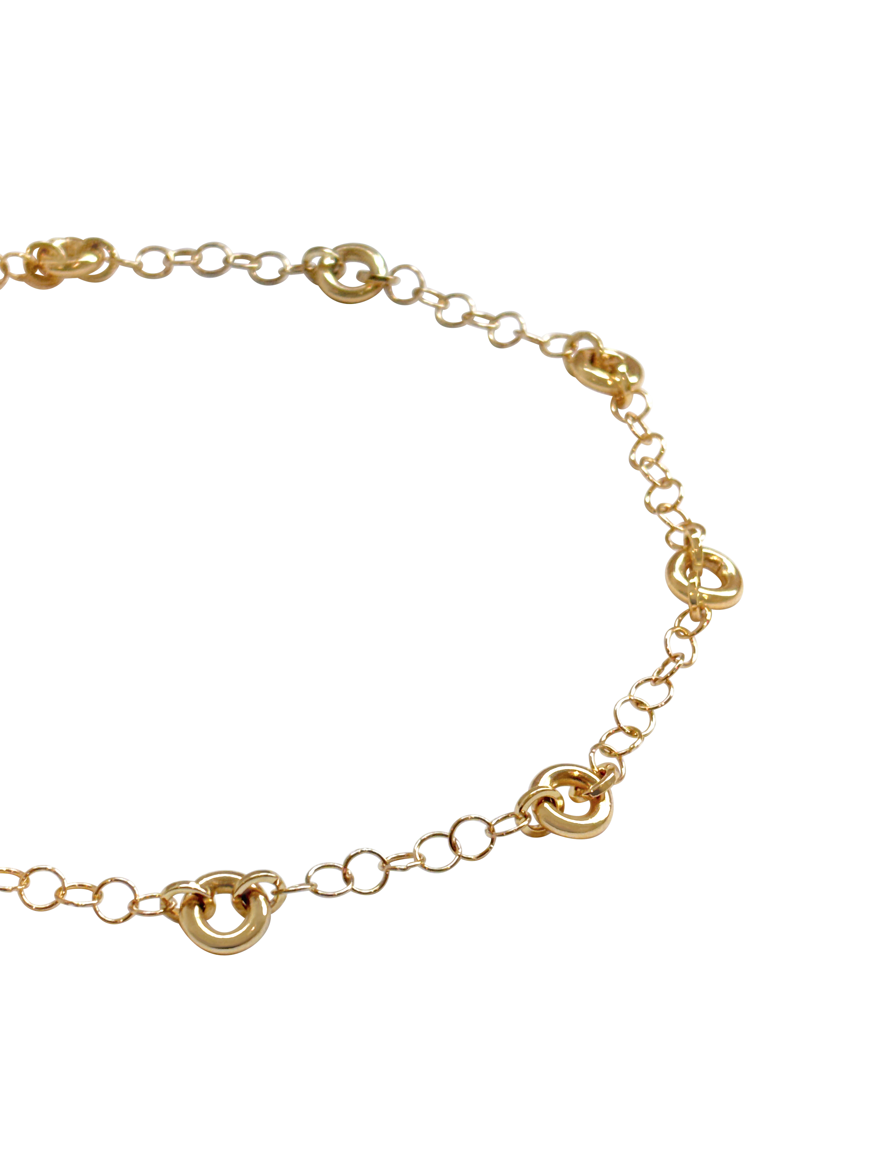 Model wearing the Astra Necklace, a delicate cable chain with circular link accents.