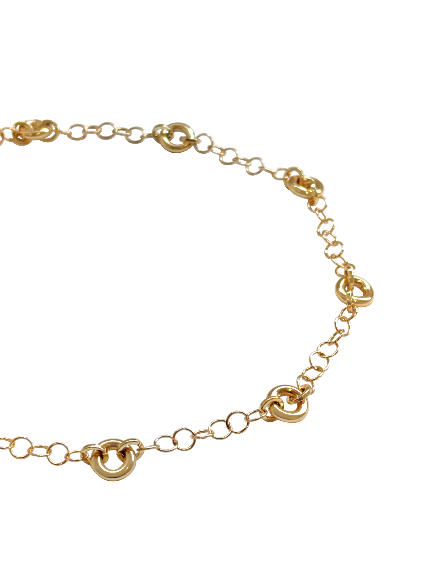Model wearing the Astra Necklace, a delicate cable chain with circular link accents.