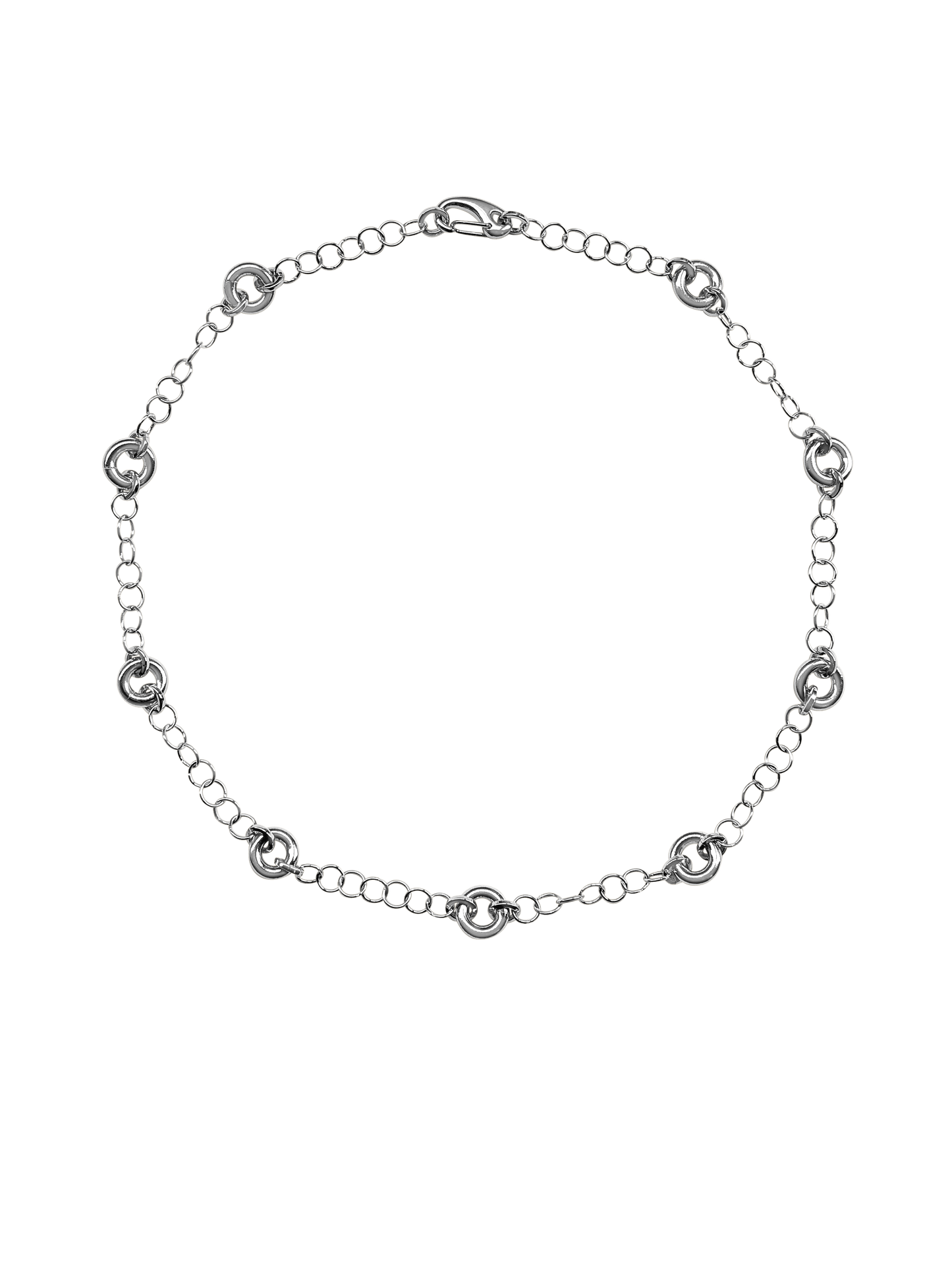 The Astra Necklace, a delicate cable chain with circular link accents in silver.