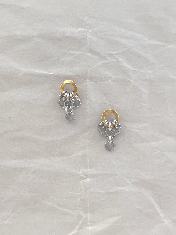 Laura Lombardi Two Tone Colonna drop earrings on a white paper background.
