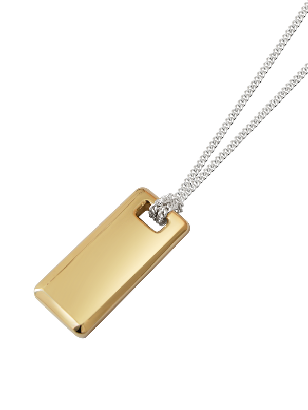 Gold rectangular pendant on a sterling silver chain against a neutral background.