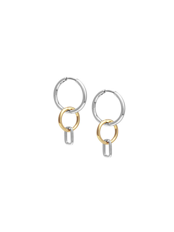 Side view of Laura Lombardi Two Tone Passa Earrings, medium silver hoops with a gold circular charm and a silver oval charm.