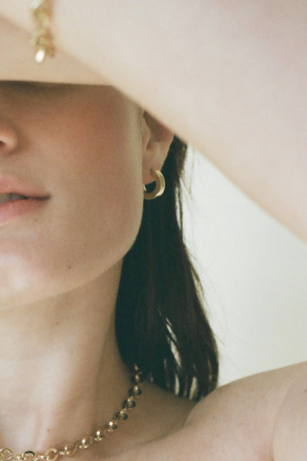 Model wearing Laura Lombardi gold Persa Earrings