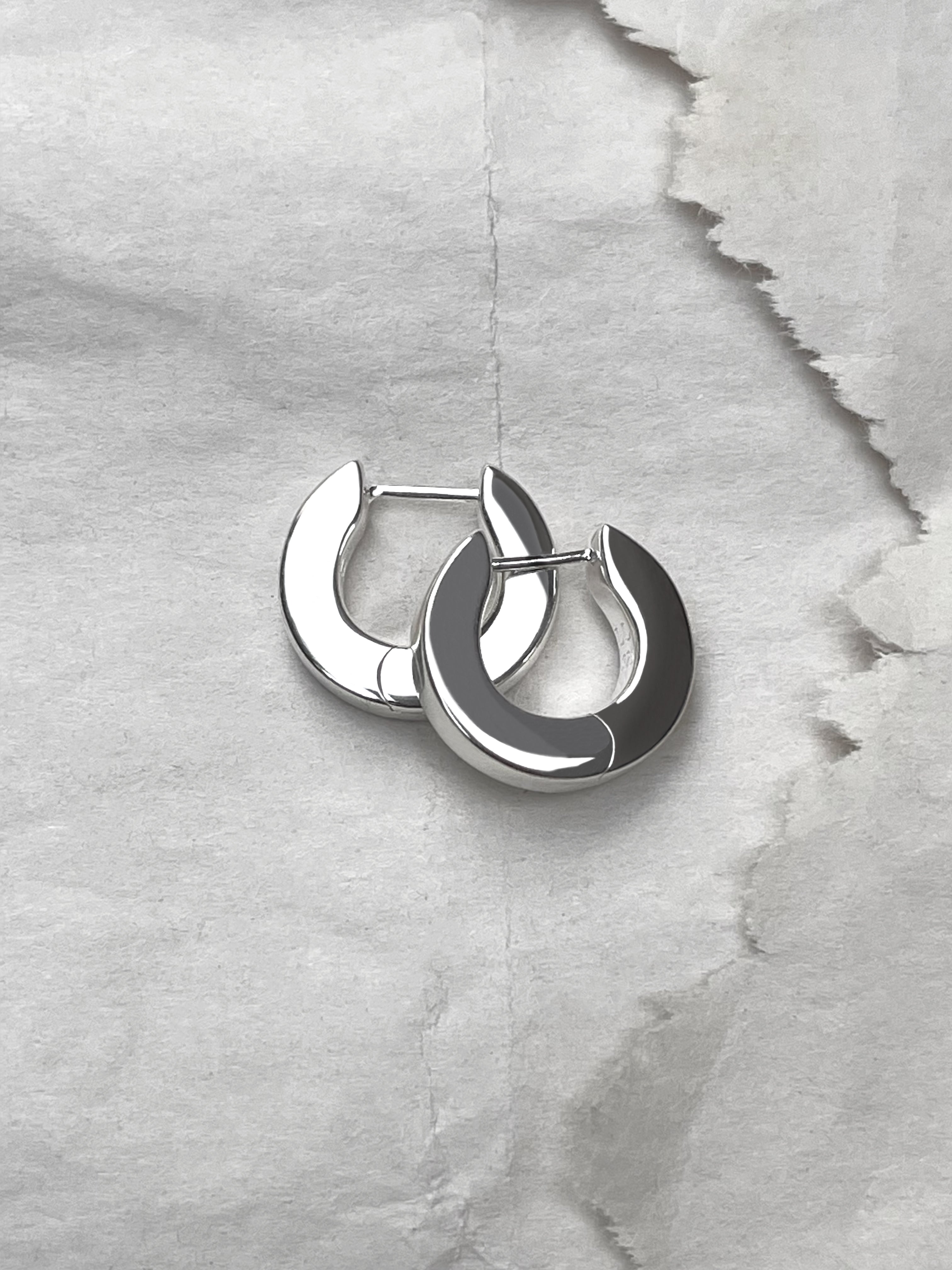 Laura Lombardi Silver Persa Earrings on paper background