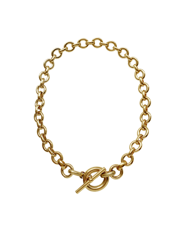 Gold chain necklace with a toggle clasp on a neutral background.