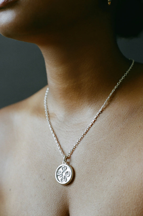 Model wearing AMS x LL Silver Seasons Pendant