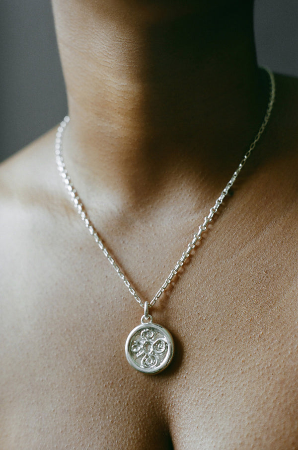 Model wearing AMS x LL Silver Seasons Pendant