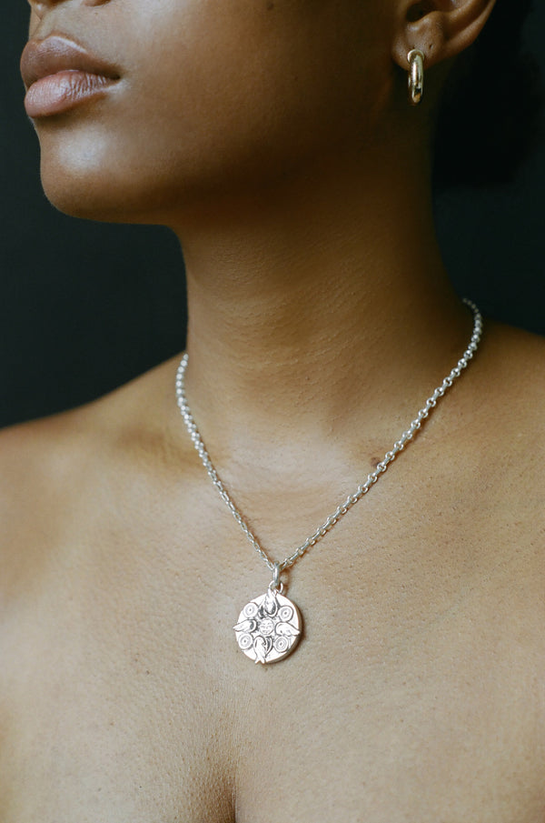 Model wearing AMS x LL Silver Seraphim Pendant