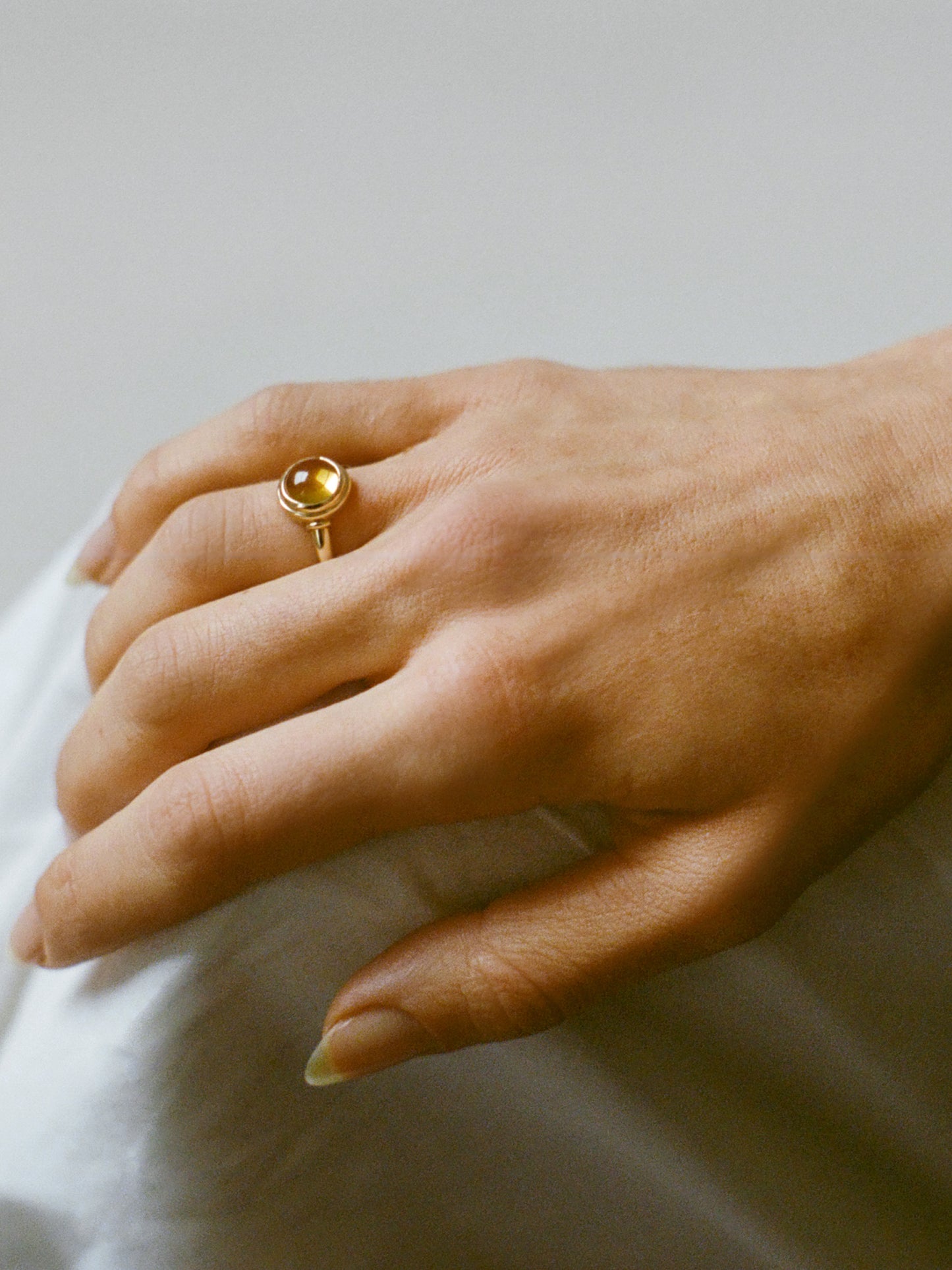 Model wearing Laura Lombardi gold Sfera Ring with yellow citrine.