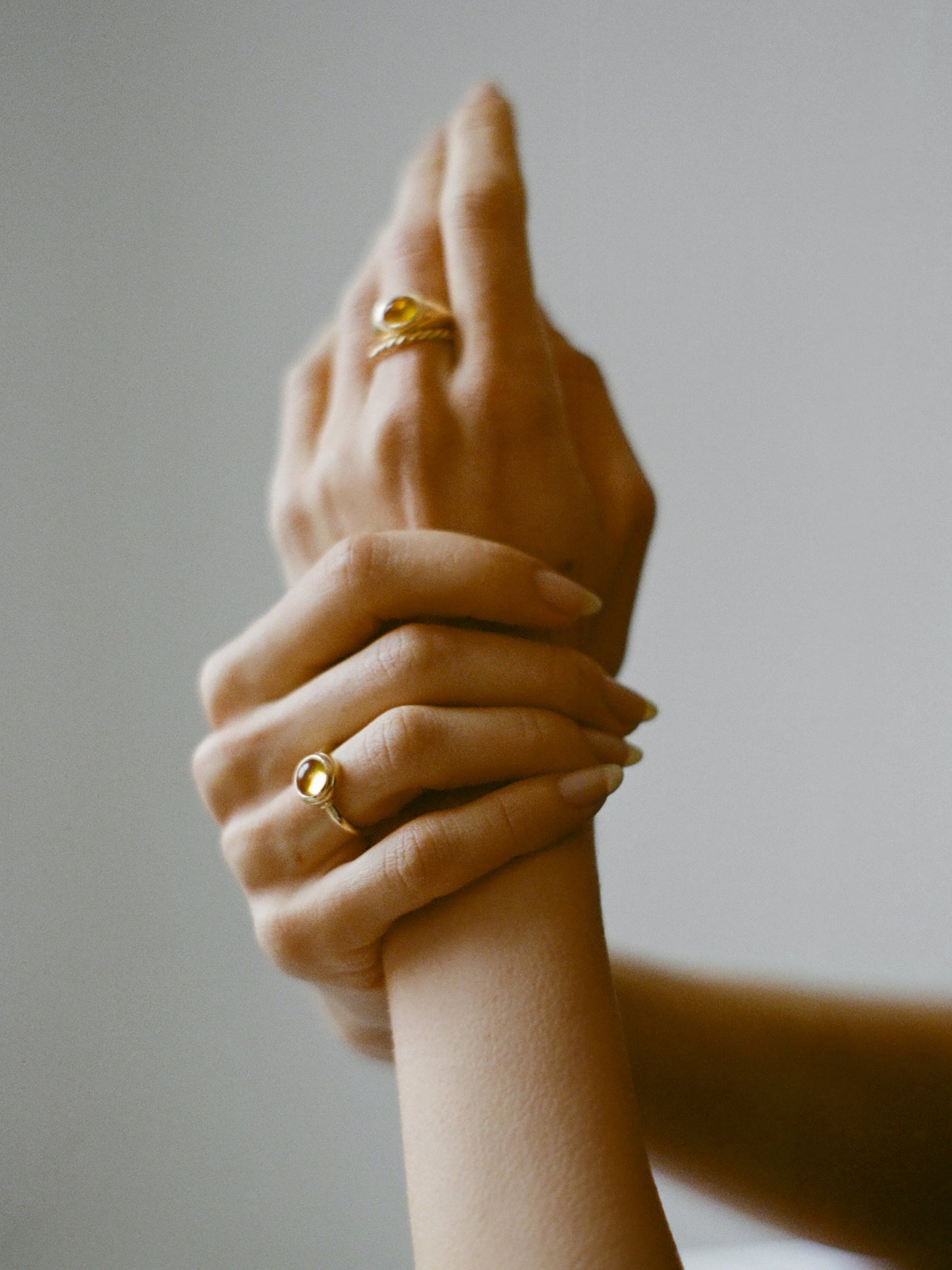Model wearing Laura Lombardi gold Sfera Ring with yellow citrine.