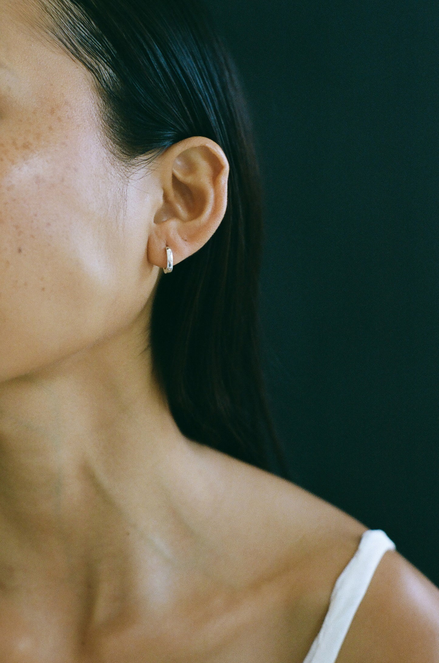 Model wearing Laura Lombardi Silver Clutch Hoops.